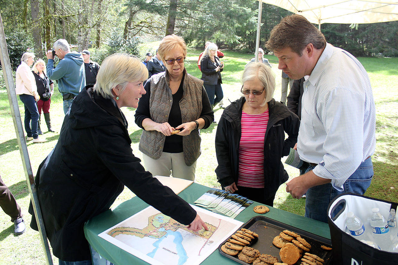 Lake Sawyer Park Foundation President Leah Grant shows King County Councilman Raegan Dunn the location of the various educational signs now scattered in the park. Photo by Ray Miller-Still