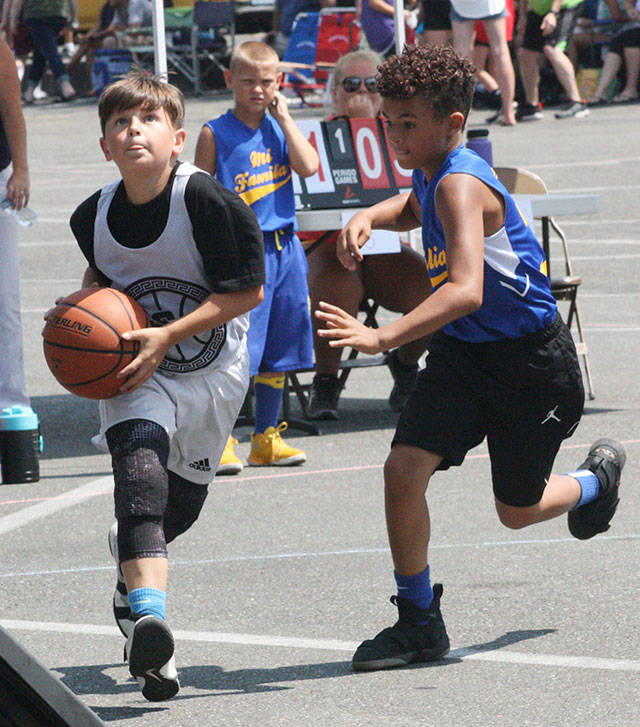 A pair of Youth Division competitors do hoop battle during last years 3-on-3 tournament. File photo by Kevin Hanson