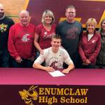 Enumclaw Highs Carson Christiansen was surrounded by family, friends, and coaches May 31 when he signed an athletic letter-of-intent with Washington State University. The Hornet senior is coming off a track and field season that saw him shine at he state championships. Competing in the Class 4A field in Tacoma, the incoming Cougar placed second in the long jump and fourth in the triple jump. Photo courtesy Enumclaw High athletics.