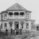 The family of Aaron, Sr. and Sarah Neely pose in front of their new Green River Valley home, east of Auburn, mid-1890s. The young boy, third from left, appears to be Aaron Neely, Jr., father of Howard Elliot Neely (see 2010 photo); Sarah Graham Neely, wife of Aaron, Sr., is on the far right. Courtesy Neely Mansion Association.