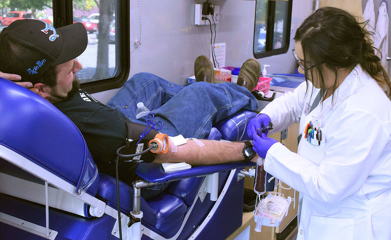 Rallying for a good cause, the community turned out Saturday for a blood drive in downtown Enumclaw. The mobile center from Bloodworks Northwest was on hand, with technicians taking blood from donors like local resident Andy Bremmeyer, pictured here. The drive was organized by downtown business owner Heather Invie, who befriended Tricia Foerster. It was Foersters dependence upon blood donors that spurred the decision to make a difference. Photo by Kevin Hanson