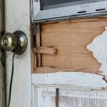 FBI officials appear to have damaged the door of Allan Thomas house when they executed a federal search warrant early Friday, July 19. Photo by Ray Miller-Still