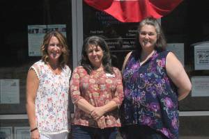 From left to right: Plateau Outreach Ministries Director Elaine Olson, Outreach Case Manager for Veterans and Seniors Lisa Napolitano, and Director Elisha Smith-Marshall stand outside of their nonprofits office. The trio work together regularly to help lift up the vulnerable populations in Enumclaw, Black Diamond and Covington.                                Photo by Danielle Chastaine