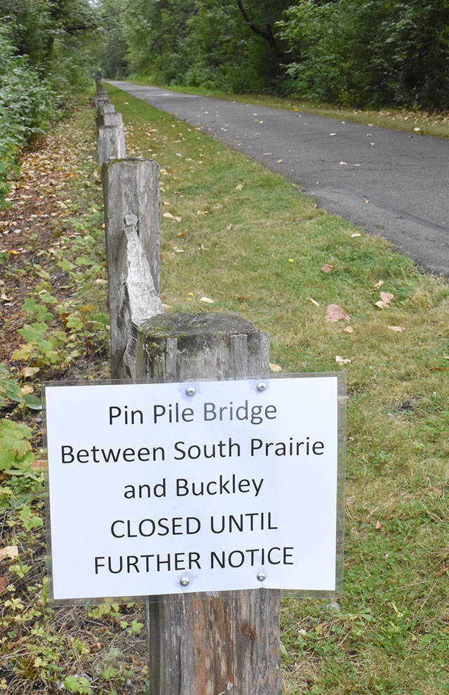 The Foothills Trail is blocked where a section of pin-pile bridge was damaged by a falling tree. This notice greets trail users where the trail crosses 112th Street in Buckley. Photo by Kevin Hanson