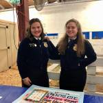 White River High School student Natalie Gomez, left, with her sister Alexandra at this years Washington State Fair, representing their schools FFA Chapter, which Natalie is president of. Contributed photo.
