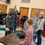 Volunteers of all ages gathered inside Buckleys City Council chambers last year to prepare lights and decorations for the first-ever Merry on Main event on Main Street. Contributed photo