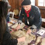 Travelers from all over attended the Third Annual Conference for Primal People at the Expo Centers Field House in May 2019, making it a hive of activity as people traded tales and examined artifacts. Pictured in one vendor showing off a Sasquatch mold to a patron. Photo by Ray Miller-Still