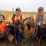 Arlin Anderson, Eric Anderson, and Jim Ritter hold up some pheasants they hunted; the birds will be served at the Wild Game Feed. Contributed photo