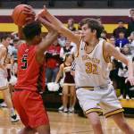 Hornet sophomore Rylan Donovan attempts to block a pass by his Cardinal opponent. Photo by Kevin Hanson