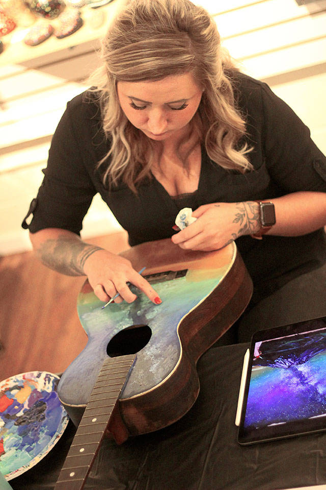 Faith Montgomery painted a galaxy on her guitar during last Novembers Freestyle Event at Arts Alive! Photo by Ray Miller-Still