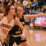 Rylie Lund tries to run past a Burlington opponent during the state regional tournament to qualify for state. Photo by Kevin Hanson