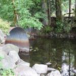 Instead of replacing these culverts that run water under 224th Avenue Southeast, the city expects to build a bridge so water from Lake Sawyer can pass unimpeded. Photo by Ray Miller-Still