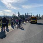 A handful of White River School District families lined up in front of a school bus to pick up sack breakfasts and lunches for their children back in March, when the pandemic began. Photo courtesy White River School District