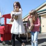 Evelyn and Emma Andreasen picking up their sack meals at Mountain Meadow Elementary in Buckley when the pandemic first started and schools closed. Photo by Ray Miller-Still