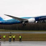 Workers cheer and wave as Boeings 787 Dreamliner takes off from Paine Field on Dec. 15, 2009. (Justin Best/ Herald file)