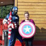 Allen Mullins, a.k.a. Captain America, stands outside the Blazing Glory coffee house off SR 410 with barista Roslyn before he took off to Yakima. Photo by Ray Miller-Still