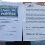 Two signs are found on the Enumclaw Youth Center window this week. The older, on the right, explains the centers March closure. The sheet on the left announces the center will now be open four hours per week. Photo by Kevin Hanson