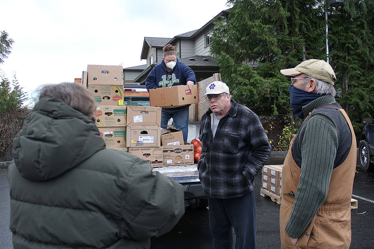 Dale Clark and several volunteers met at the Buckley Church of Latter Day Saints to distribute food to volunteer ambassadors from all over King and Pierce County. Photo by Ray Miller-Still