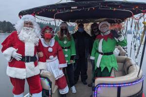 Pictured left to right is Bill Swedberg (Santa), Jan Capetto (Mrs. Claus), Cara Porter (elf) Scott Sherer (captain), Jonny Hoefig (gaffer), and Sue Sherer. Photo courtesy Lauren Landis