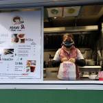 Mananchaya Nong Thakwang packaging up a call-in order at Dwight Garrett Park in Enumclaw. Photo by Ray Miller-Still