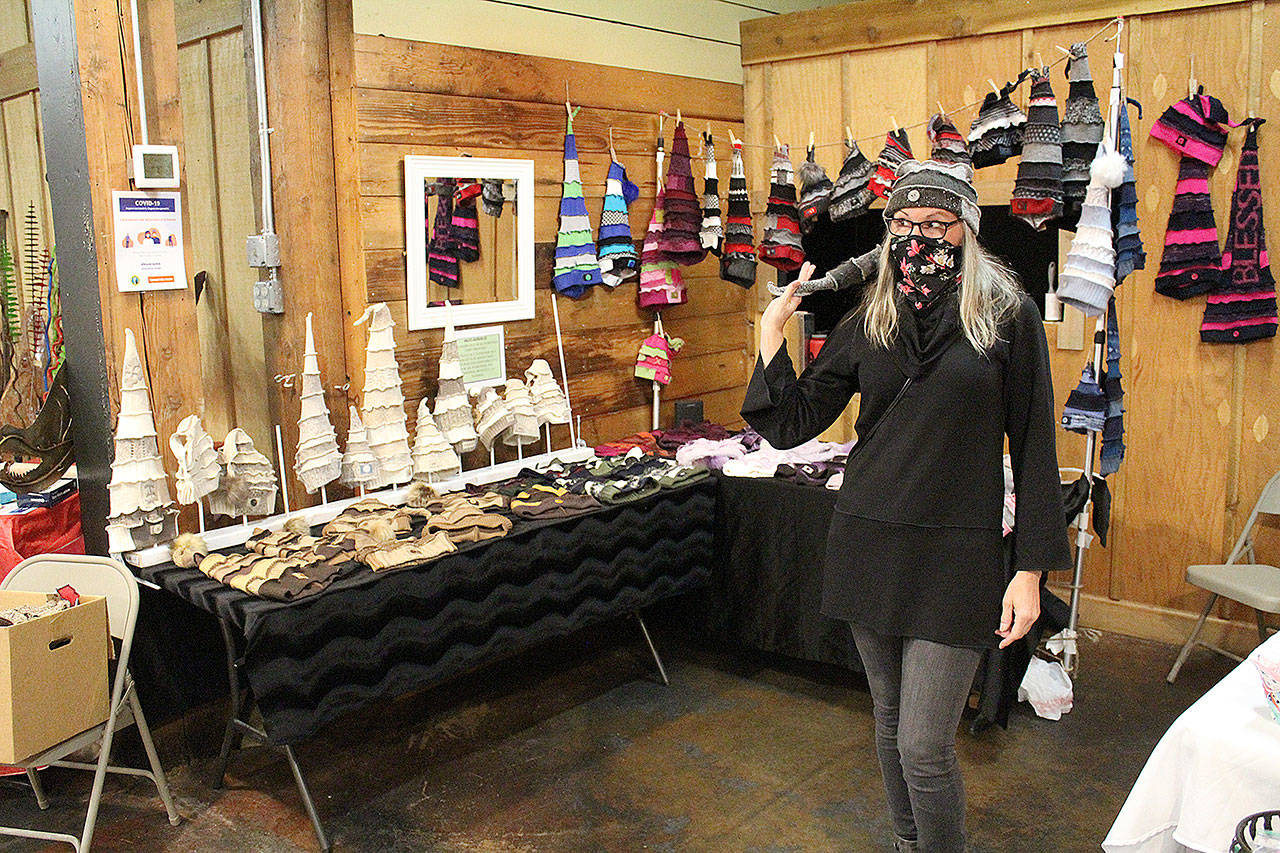 Kim Smasne says many people first think the hats she makes are just for kids, but that they often change their minds after trying one on. When you put these on, youre going to feel funky, fun, flirty  and Im not just saying that to sell you a hat, she said. In this picture, Smasne is selling her wares at Enumclaws Friday Night Market. Photo by Ray Miller-Still