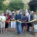 This group of local volunteers got together in September 2019 as a part of a Rural Development Initiative program that aimed to help locals develop leadership skills before sending them off to perform their own community project with a small budget. Pictured is Rick Sellers, Ramsey Graham, Lacey Mansanarez, Sue Hart, Peggy Levesque, Mayor Jeff Sellers, Alli Brewer, Leah Haugen, Trip Hart, David McArtor, Jan Burley, Deyton Cunningham, and Venise Cummingham as they cut the ribbon on a community garden in Wilkeson when the project finished summer of 2020. Photo by Ray Miller-Still