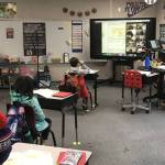 An Island Park Elementary teacher and her students hit the books on Feb. 8 in the Mercer Island School District. The single largest amount of Gov. Jay Inslees newly announce relief package, $668 million, will go to public elementary and secondary schools to prepare for reopening for some in-person learning and to address students learning loss. Courtesy photo
