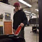 Photo by Alex Bruell
Josh Sanders flips up the tail light of a Corvette on March 5 in his Enumclaw shop. The flipping light is a creative modification he spent a week working on that enables other work on the vehicle to go smoothly.