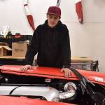 Josh Sanders looks over the engine bay of the 1959 Corvette in his Enumclaw shop March 5. Photo by Alex Bruell