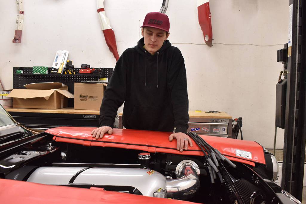 Josh Sanders looks over the engine bay of the 1959 Corvette in his Enumclaw shop March 5. Photo by Alex Bruell