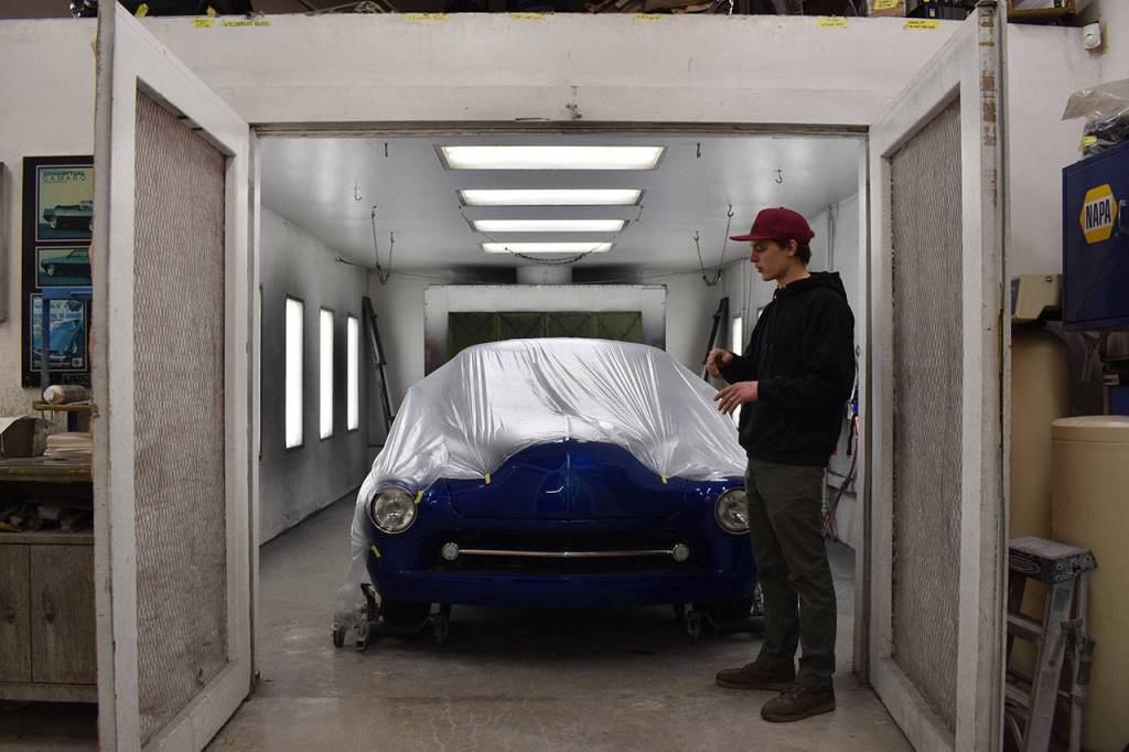 Josh Sanders shows off a vehicle on March 5 in the paint shop of his Enumclaw auto shop thats received repairs and a really tricky tri-coat metallic paint job. Photo by Alex Bruell