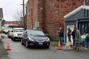 Customers of the Buckley Plateau Market line up in an alley way to receive their orders. Photo courtesy Sean Shands