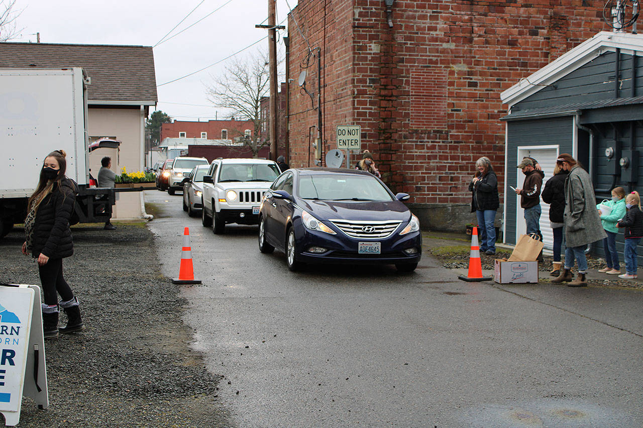 Customers of the Buckley Plateau Market line up in an alley way to receive their orders. Photo courtesy Sean Shands