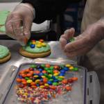 Dylan Pierucci places the finishing touches on a batch of cookies March 16 at the Buckley Kitchen. Photo by Alex Bruell