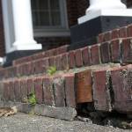 Enumclaws City Halls front steps are in desperate need of repair; some of the paver bricks, like you see here, have simply been replaced with wooden blocks. Photo by Ray Miller-Still