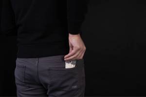 "A man takes out a plastic bag from a pocket with a dose of cocaine or another concept of drugs." Photo courtesy Marco Verch, licensed under CC BY 2.0