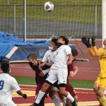 With Hornets and Trojans battling for position in front of the net, White River goalkeeper Nick Panin prepares to make a save during Thursday night's contest on the White River High campus. In an exciting contest that went into a shootout, the visitors from Fife High escaped with a win to take the postseason title. Photo by Kevin Hanson