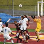 With Hornets and Trojans battling for position in front of the net, White River goalkeeper Nick Panin prepares to make a save during Thursday nights contest on the White River High campus. In an exciting contest that went into a shootout, the visitors from Fife High escaped with a win to take the postseason title. Photo by Kevin Hanson
