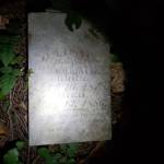 This photo, uploaded to Facebook on October 1 by Dustin Baccetti, shows the grave marker where he discovered it in the woods near his residence.
