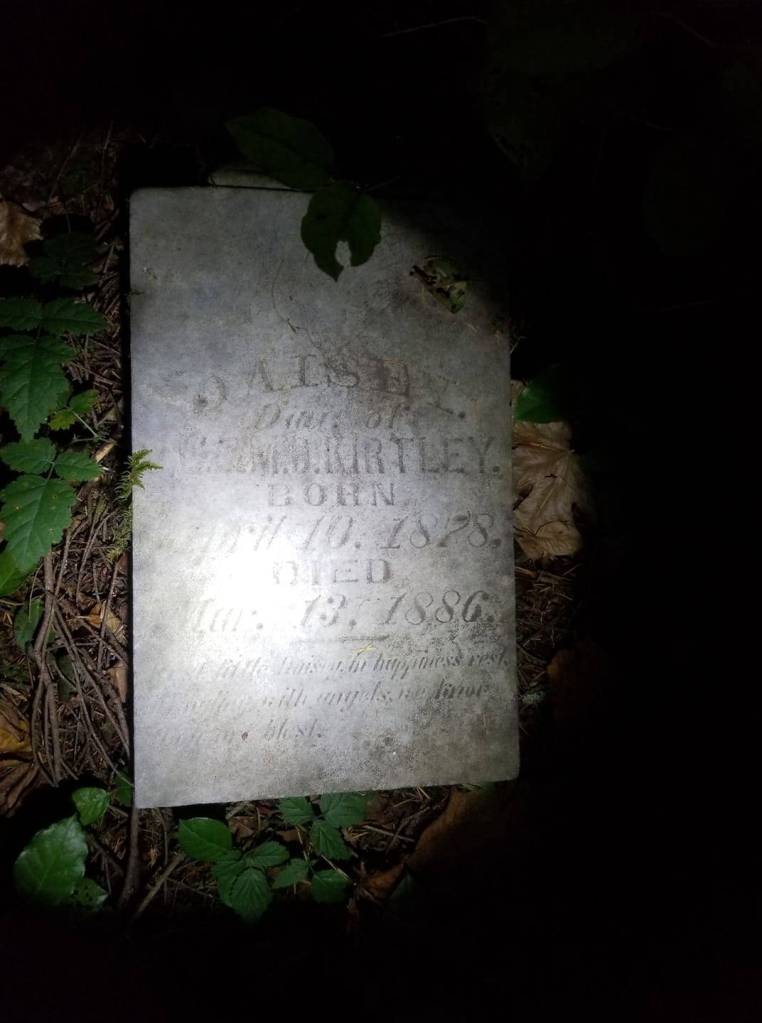This photo, uploaded to Facebook on October 1 by Dustin Baccetti, shows the grave marker where he discovered it in the woods near his residence.