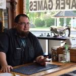 Ian McLeod speaks with customers behind the desk at Rock Paper Games on Main Street in Buckley on the afternoon of May 11. Photo by Alex Bruell