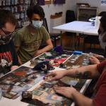 A group of gamers plays Magic: The Gathering at Rock Paper Games. Photo by Alex Bruell