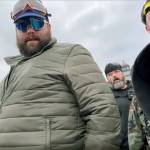 Daniel Scott (center, in green jacket) is shown in a video before the Proud Boys and other rioters stormed the U.S. Capitol building on Jan. 6 in Washington, D.C.