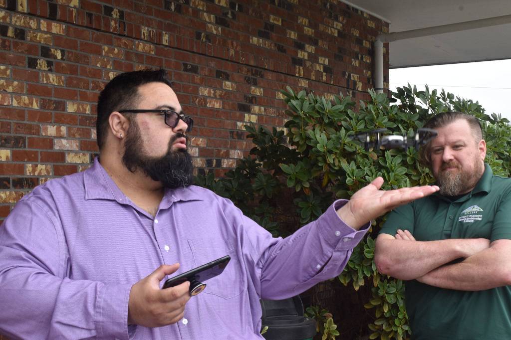 Photo by Alex Bruell 
Andrew Bruce shows off one of his smallest drones as it takes off from the palm of his hand.