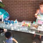 Summer Food Program workers prepare to serve from a site at the Enumclaw library in summer 2018. Enumclaw High School, Byron Kibler Elementary School and Black Diamond Elementary will be the distribution points instead in 2021. Photo courtesy Enumclaw School District.