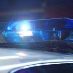 Police at night in the car with blue siren flasher. Siren on police car flashing, close-up. Police light and siren on the car in action. Emergency flashing police siren during night period. Police signal flasher isolated.