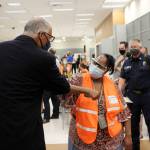 Gov. Jay Inslee (left) bumps elbows with Auburn Vaccine Clinic staff member Mary Johnson (right) on June 22, 2021. Inslee visited the clinic to promote vaccinations in lower King County. Photo by Henry Stewart-Wood/Sound Publishing