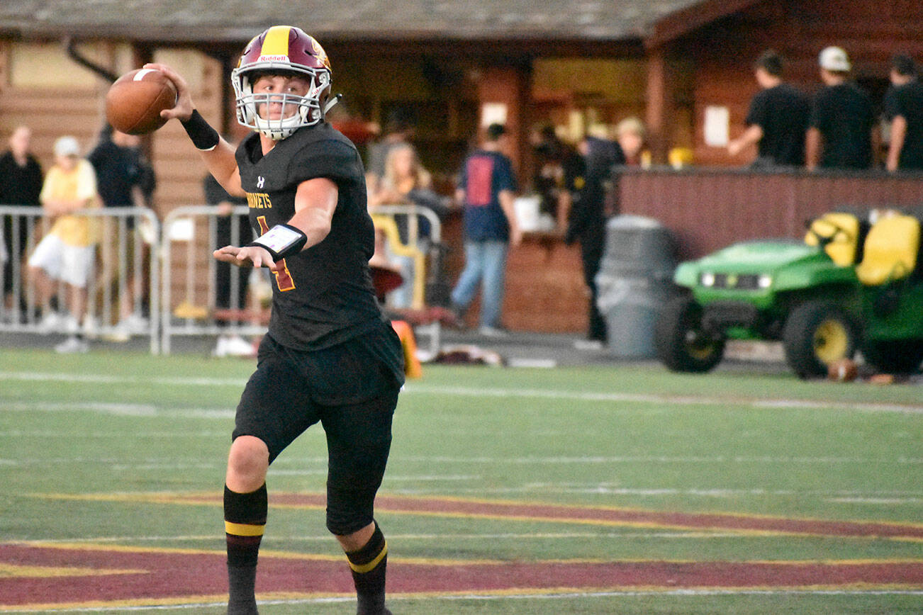PHOTO BY KEVIN HANSON Enumclaw quarterback Malcolm Harper looks for a receiver during the first half of the Hornets Week 2 victory over the Lakes Lancers.
