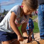 Photo by Ashley Britschgi 
Paislee Olson sets a choker around a log of wood.