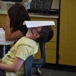 This school year and the last are different, but some things never change - like a kids instinct to have fun. When third grade teacher Jody Emerson asked students to place their assignments on their heads so she could collect them, one student laid back and did just so. Photo by Alex Bruell